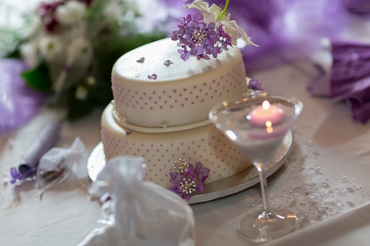 Traditional wedding cake with purple flowers