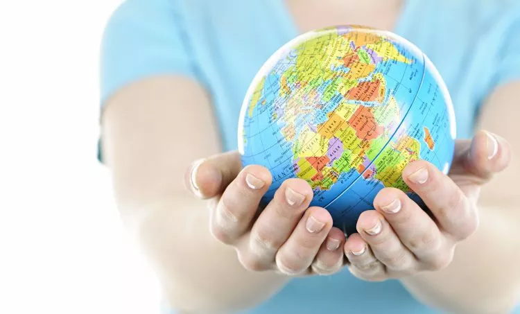 Hands holding globe